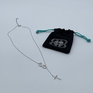 Beaux Bijoux silver tone Infiniti with cross necklace